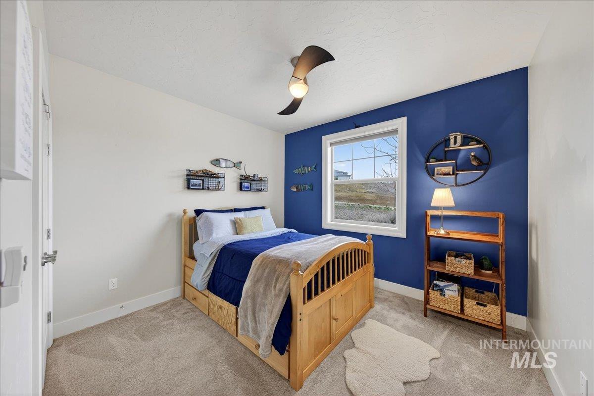 24813 Valley Run Place Star, ID 83669 - Photo 22 of 50 Carpeted bedroom featuring a ceiling fan and a textured ceiling