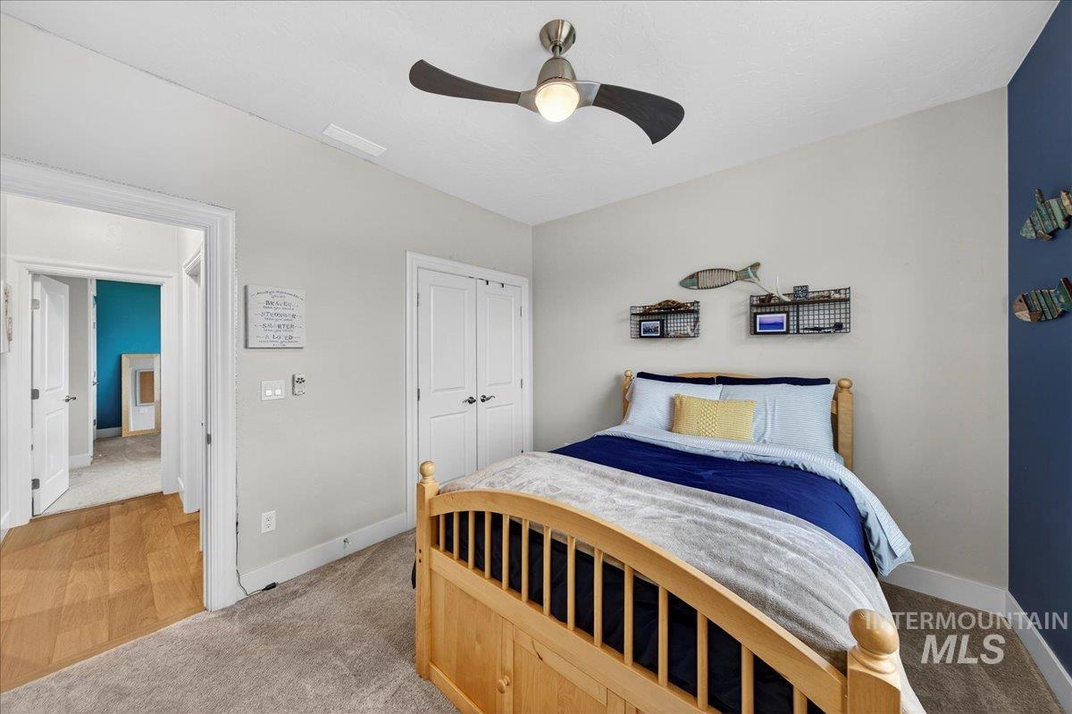 24813 Valley Run Place Star, ID 83669 - Photo 23 of 50 Bedroom featuring light carpet, ceiling fan, and a closet