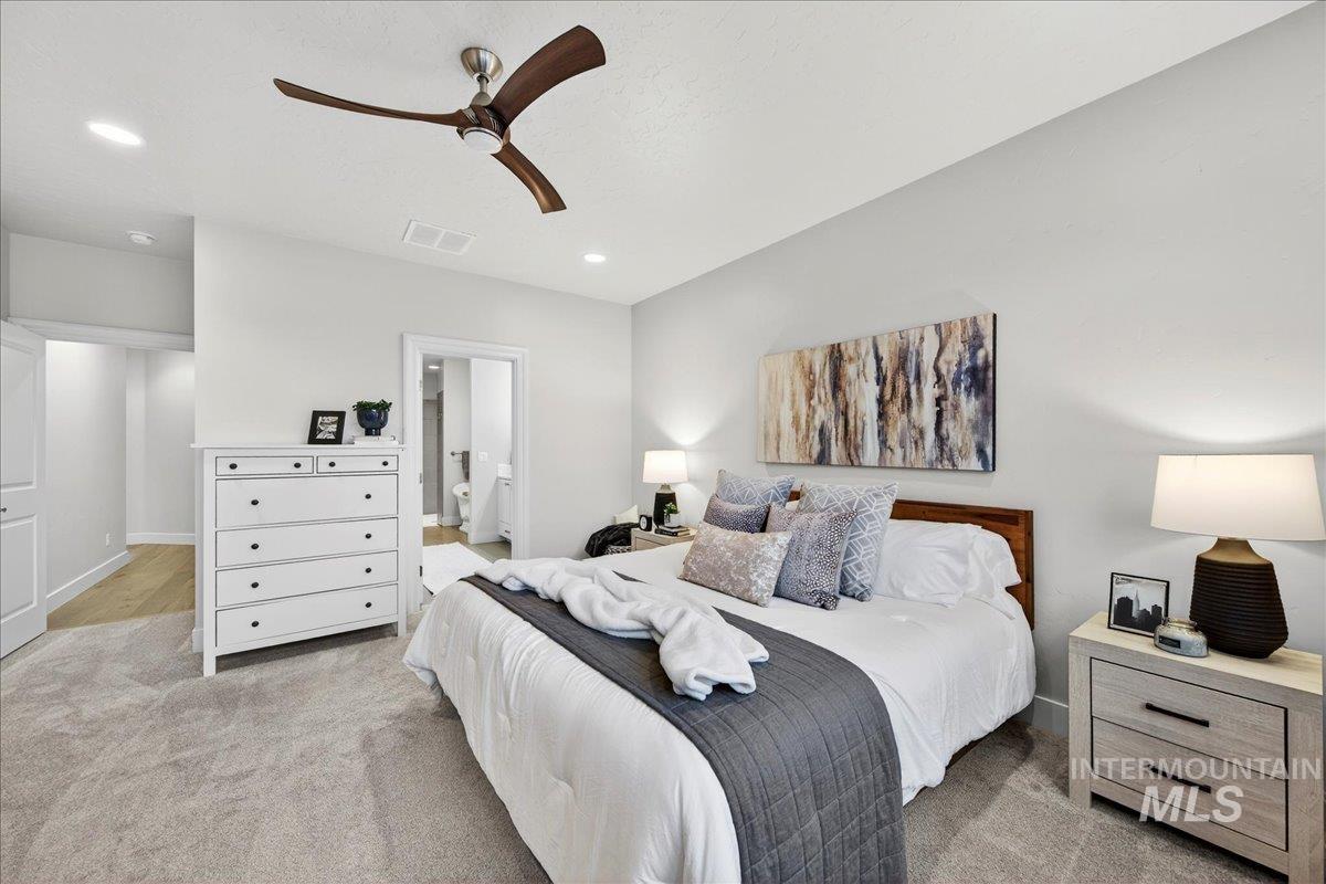 24813 Valley Run Place Star, ID 83669 - Photo 28 of 50 Bedroom with light colored carpet, ensuite bath, ceiling fan, and recessed lighting