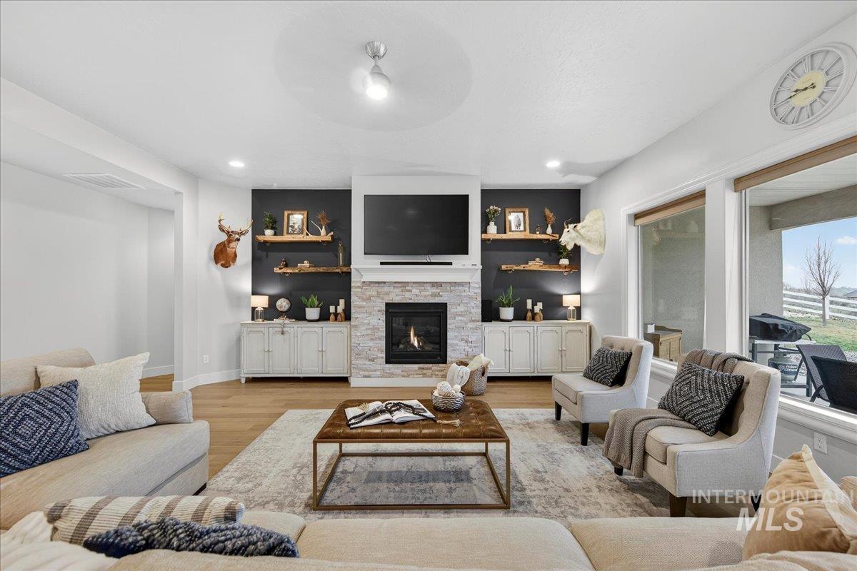 24813 Valley Run Place Star, ID 83669 - Photo 3 of 50 Living area with light wood-style floors and a fireplace