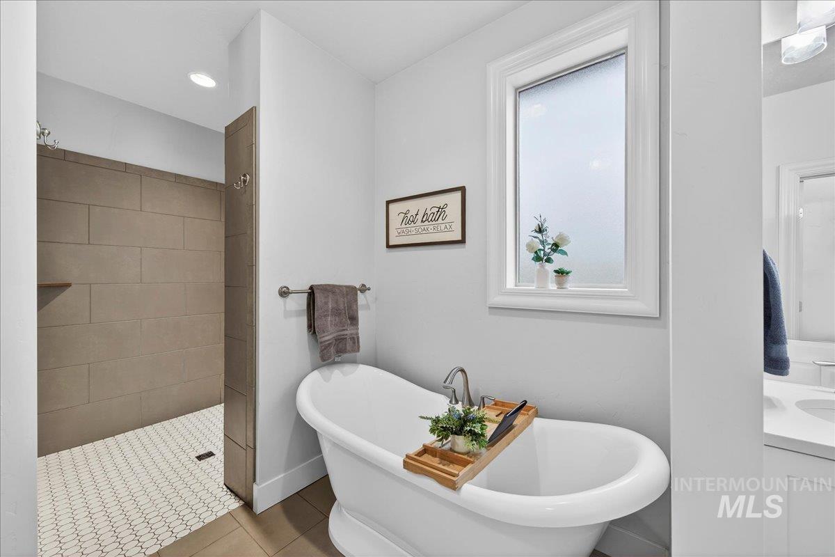 24813 Valley Run Place Star, ID 83669 - Photo 32 of 50 Bathroom featuring a soaking tub, tile patterned floors, vanity, walk in shower, and recessed lighting
