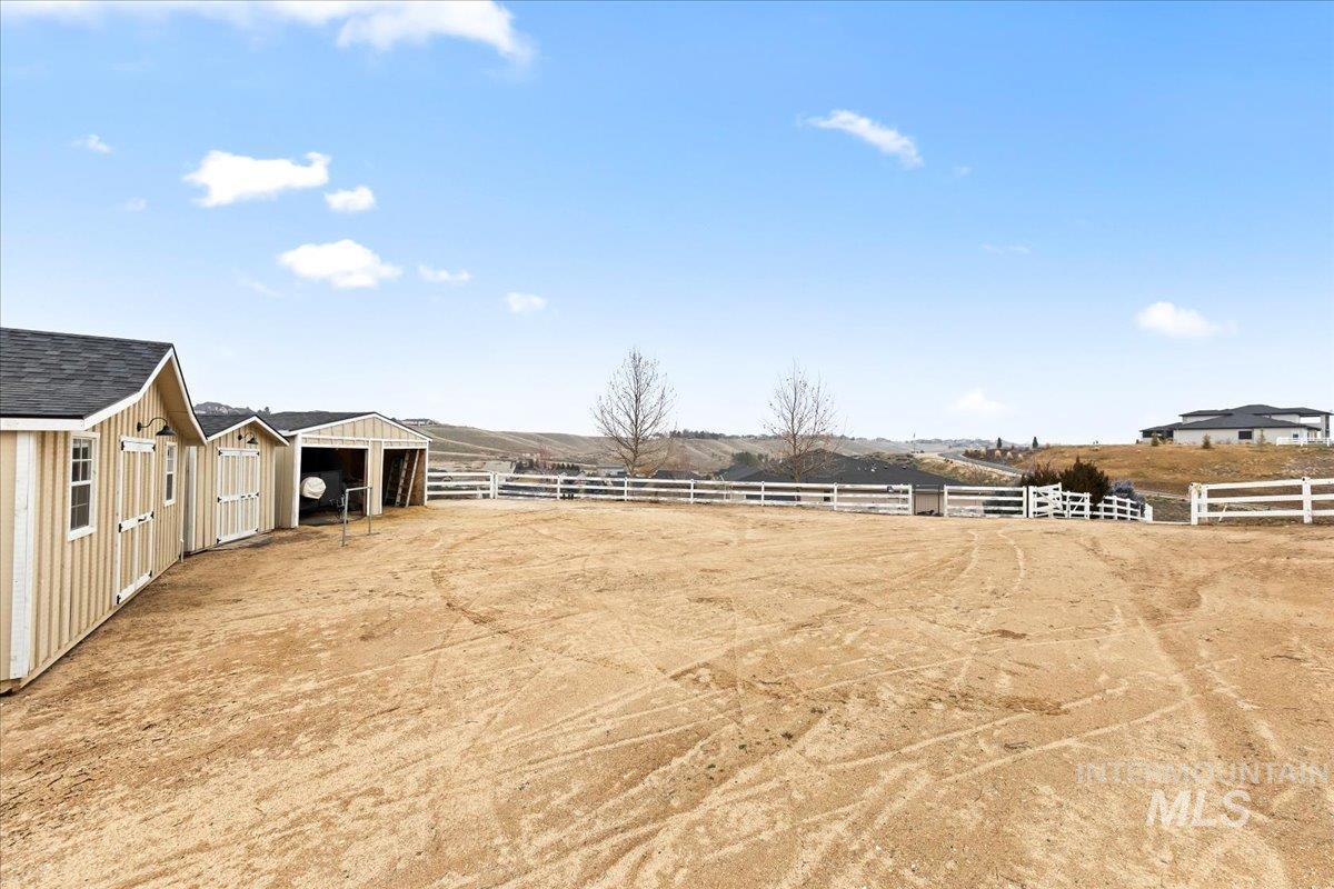24813 Valley Run Place Star, ID 83669 - Photo 43 of 50 View of yard with an outdoor structure, an enclosed horse arena, and a rural view