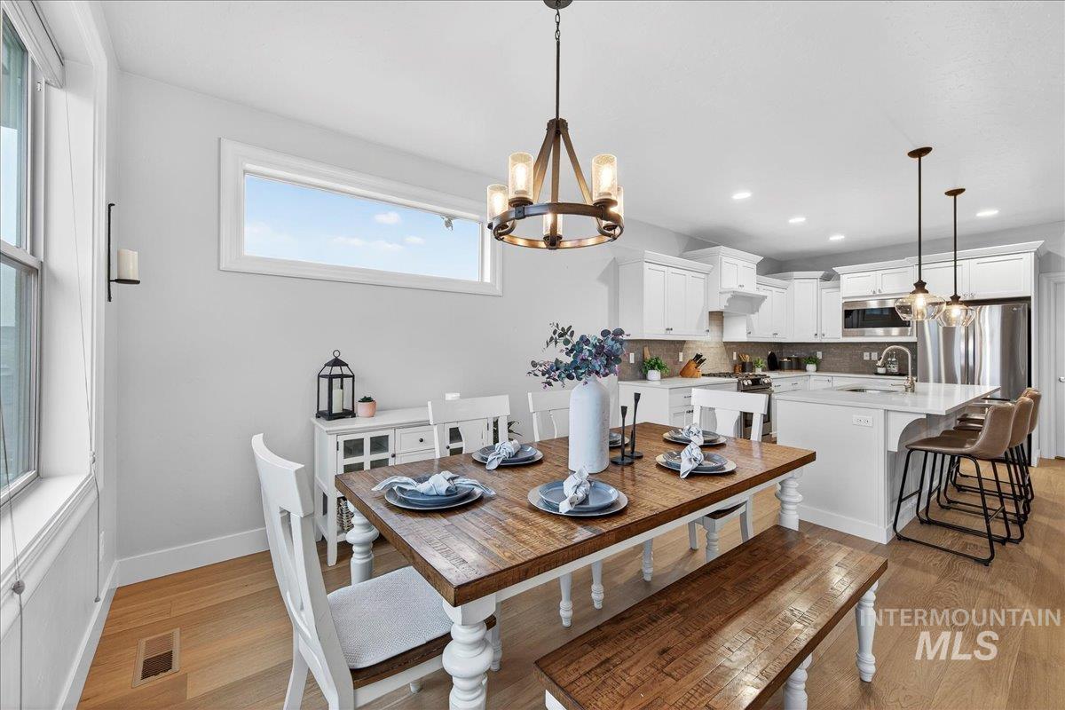 24813 Valley Run Place Star, ID 83669 - Photo 5 of 50 Dining room featuring a chandelier, light wood-type flooring, and recessed lighting