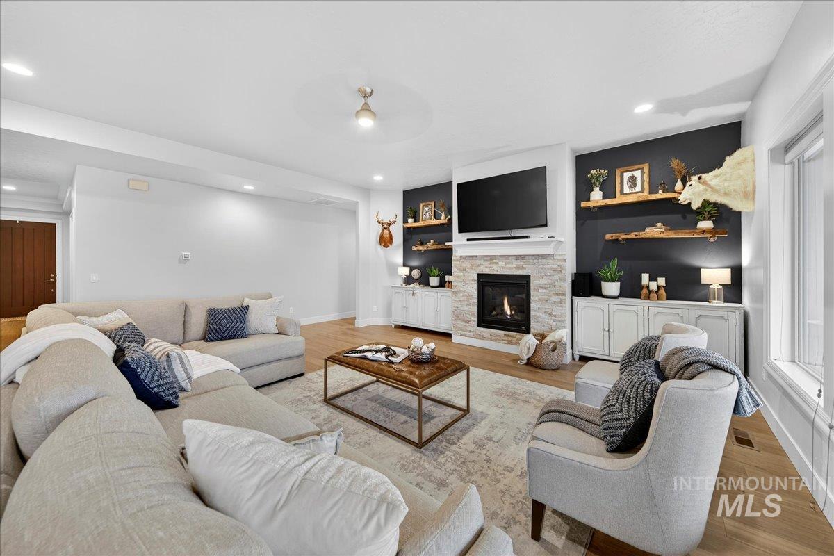 24813 Valley Run Place Star, ID 83669 - Photo 7 of 50 Living area featuring a fireplace, wood finished floors, and recessed lighting
