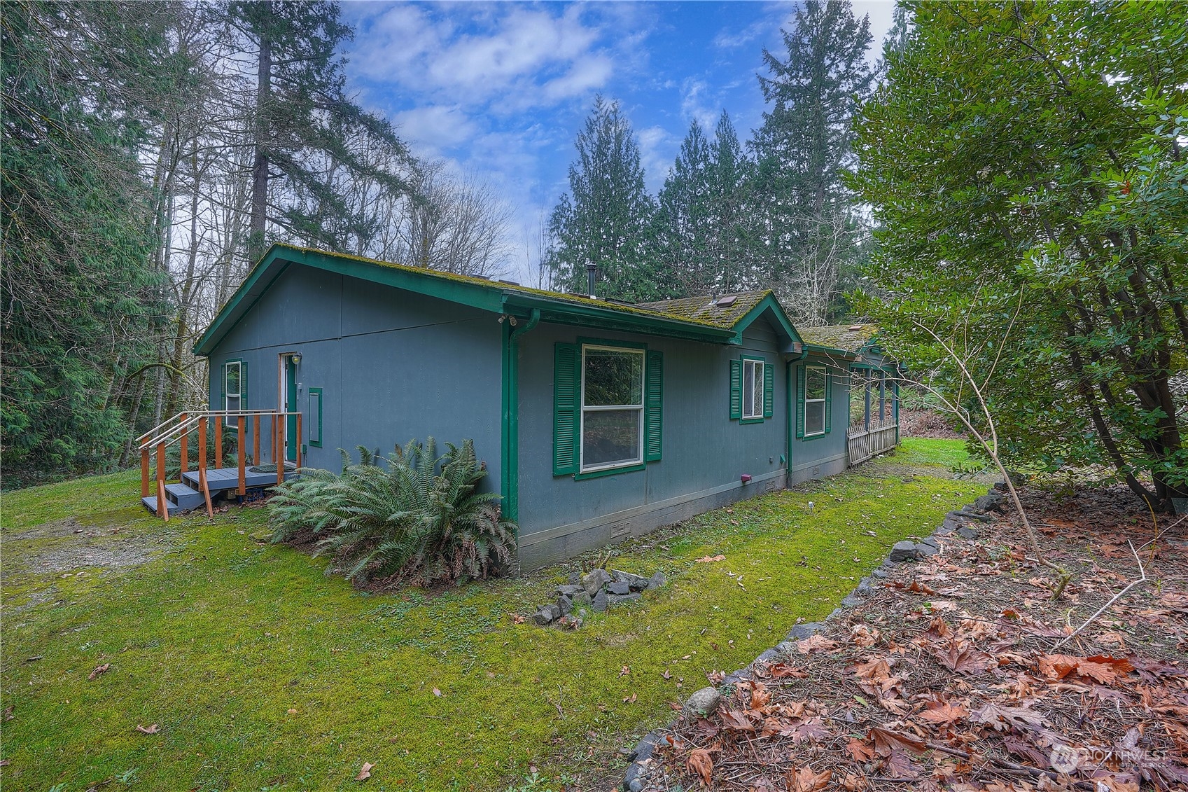 17908 Erickson Road Southwest Longbranch, WA 98351 - Photo 1 of 30 a view of a house with a yard plants and large tree