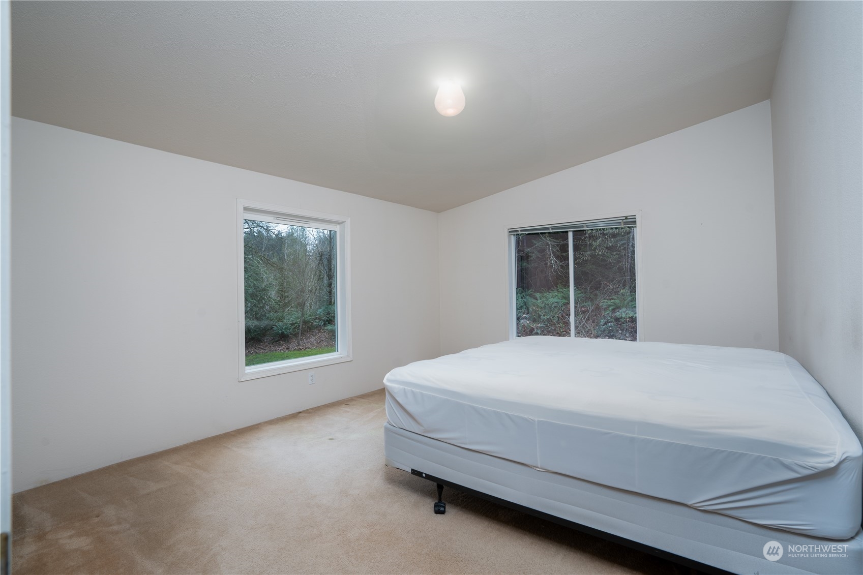 17908 Erickson Road Southwest Longbranch, WA 98351 - Photo 12 of 30 a room with a bed and a window