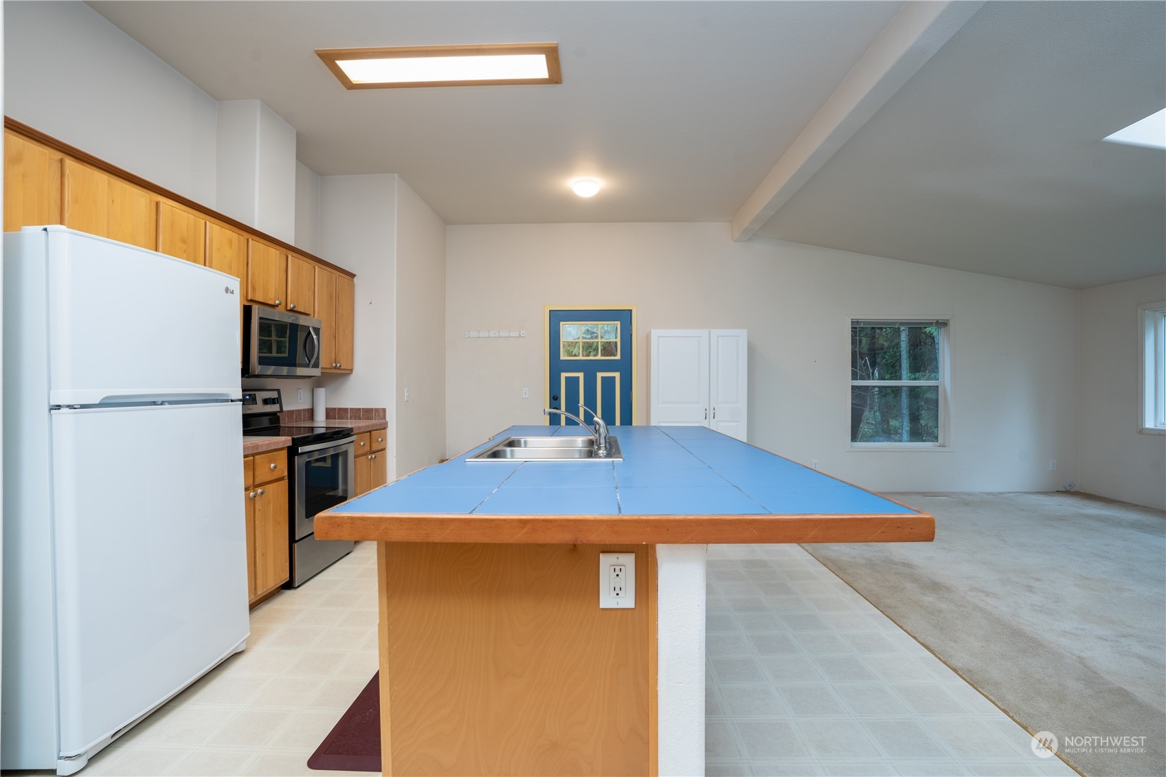 17908 Erickson Road Southwest Longbranch, WA 98351 - Photo 4 of 30 a kitchen with stainless steel appliances kitchen island a refrigerator sink and stove