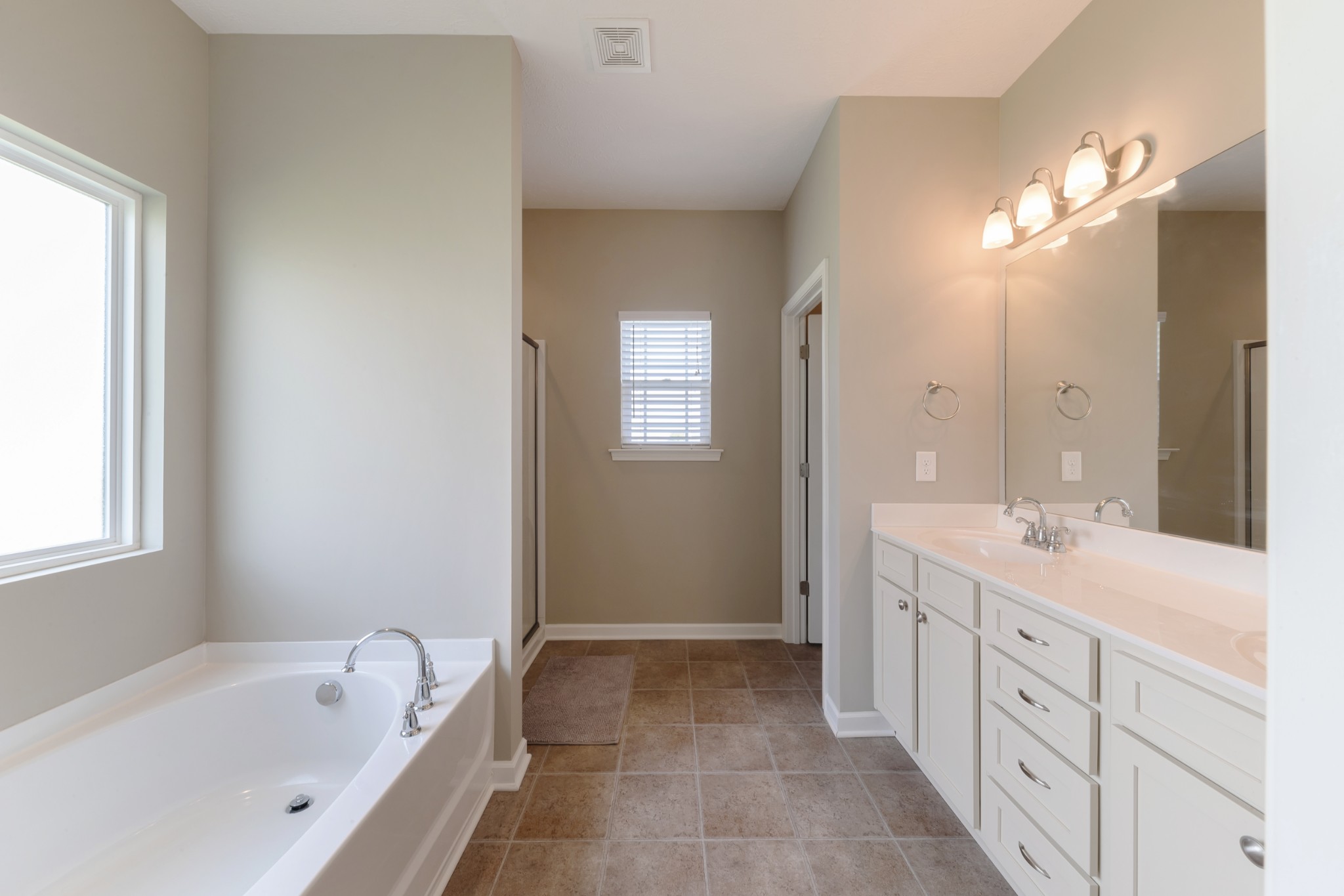 1426 Alamo Avenue Murfreesboro, TN 37129 - Photo 17 of 34 a spacious bathroom with a bathtub sink and mirror
