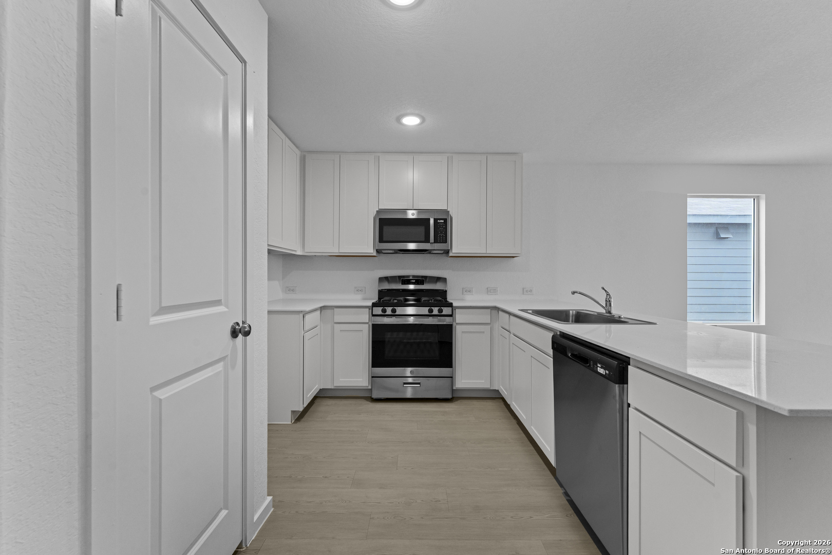 1834 Stonechat New Braunfels, TX 78130 - Photo 5 of 29 a kitchen with a sink and a stove top oven