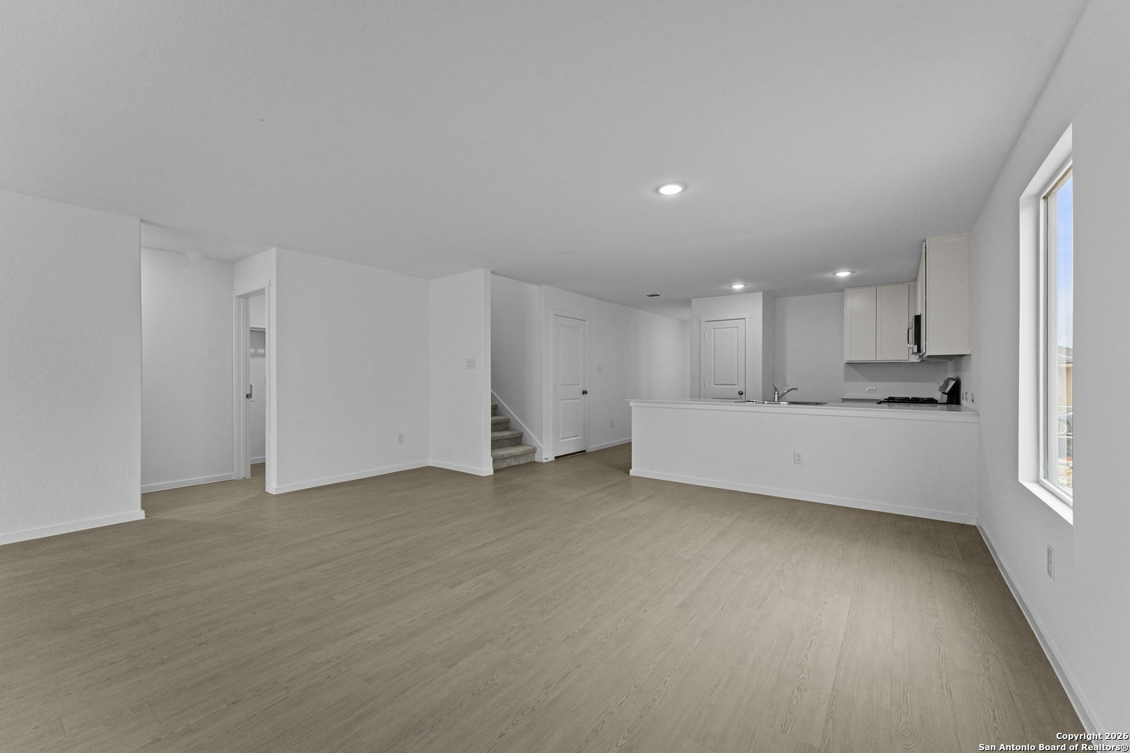 1834 Stonechat New Braunfels, TX 78130 - Photo 9 of 29 a view of an empty room with kitchen and window