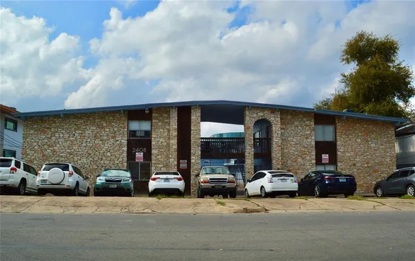 a couple of cars parked in front of building