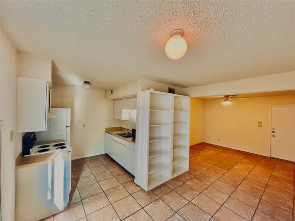 a view of a kitchen with white cabinets