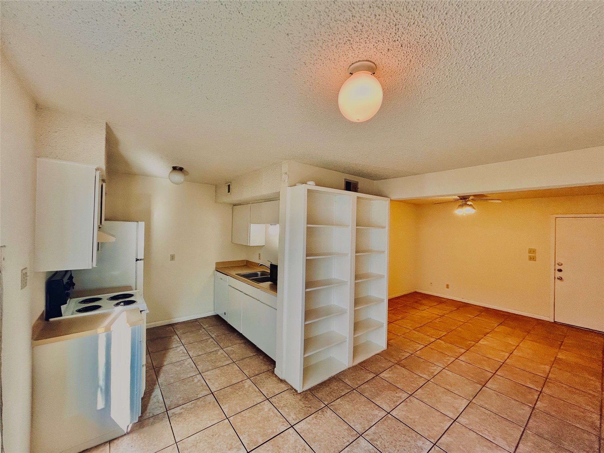 2408 Longview Street, Unit 110 Austin, TX 78705 - Photo 4 of 9 a view of a kitchen with white cabinets