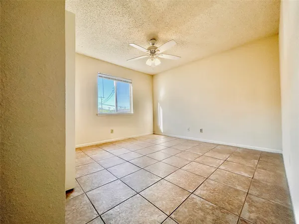 a view of a room with window and ceiling fan