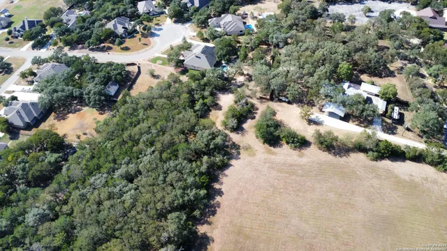 an aerial view of a houses with a yard