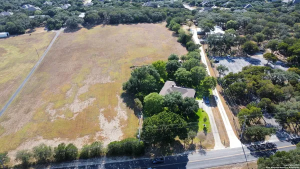 an aerial view of house with yard and outdoor seating