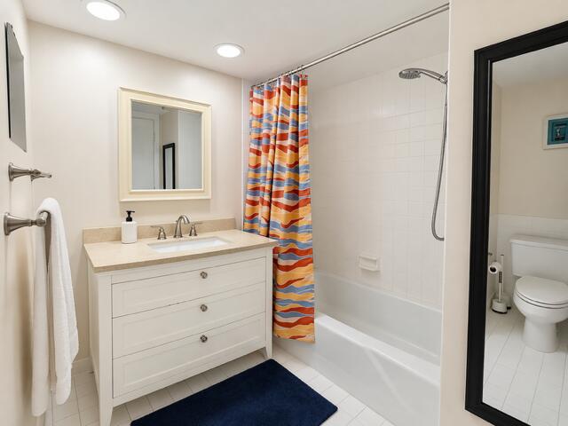 800 East Camino Real, Unit 416 Boca Raton, FL 33432 - Photo 13 of 18 a bathroom with a sink a toilet and shower