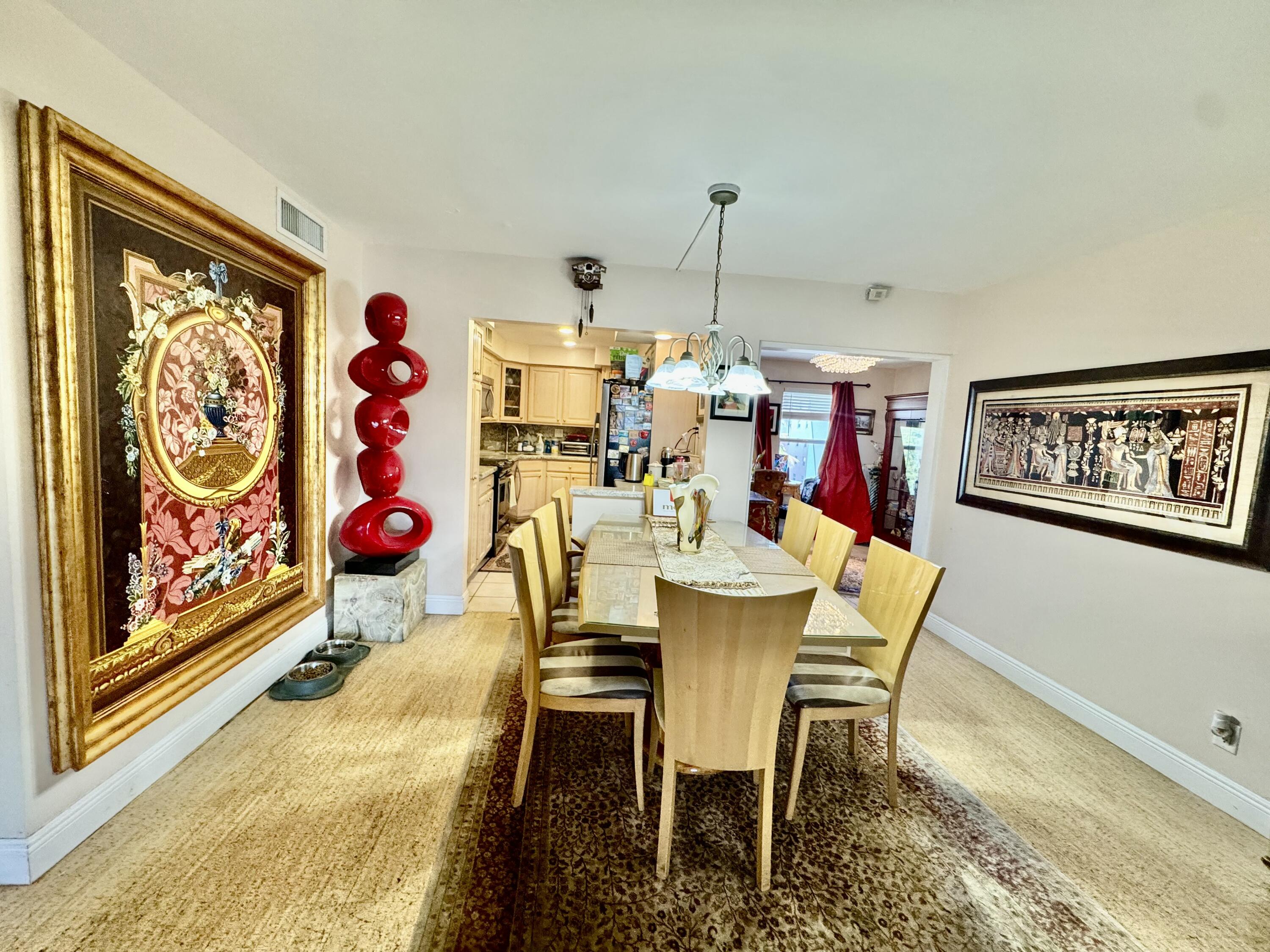 800 East Camino Real, Unit 416 Boca Raton, FL 33432 - Photo 3 of 18 a view of a dining room with furniture and chandelier