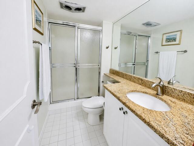 800 East Camino Real, Unit 416 Boca Raton, FL 33432 - Photo 9 of 18 a bathroom with a granite countertop sink toilet and shower