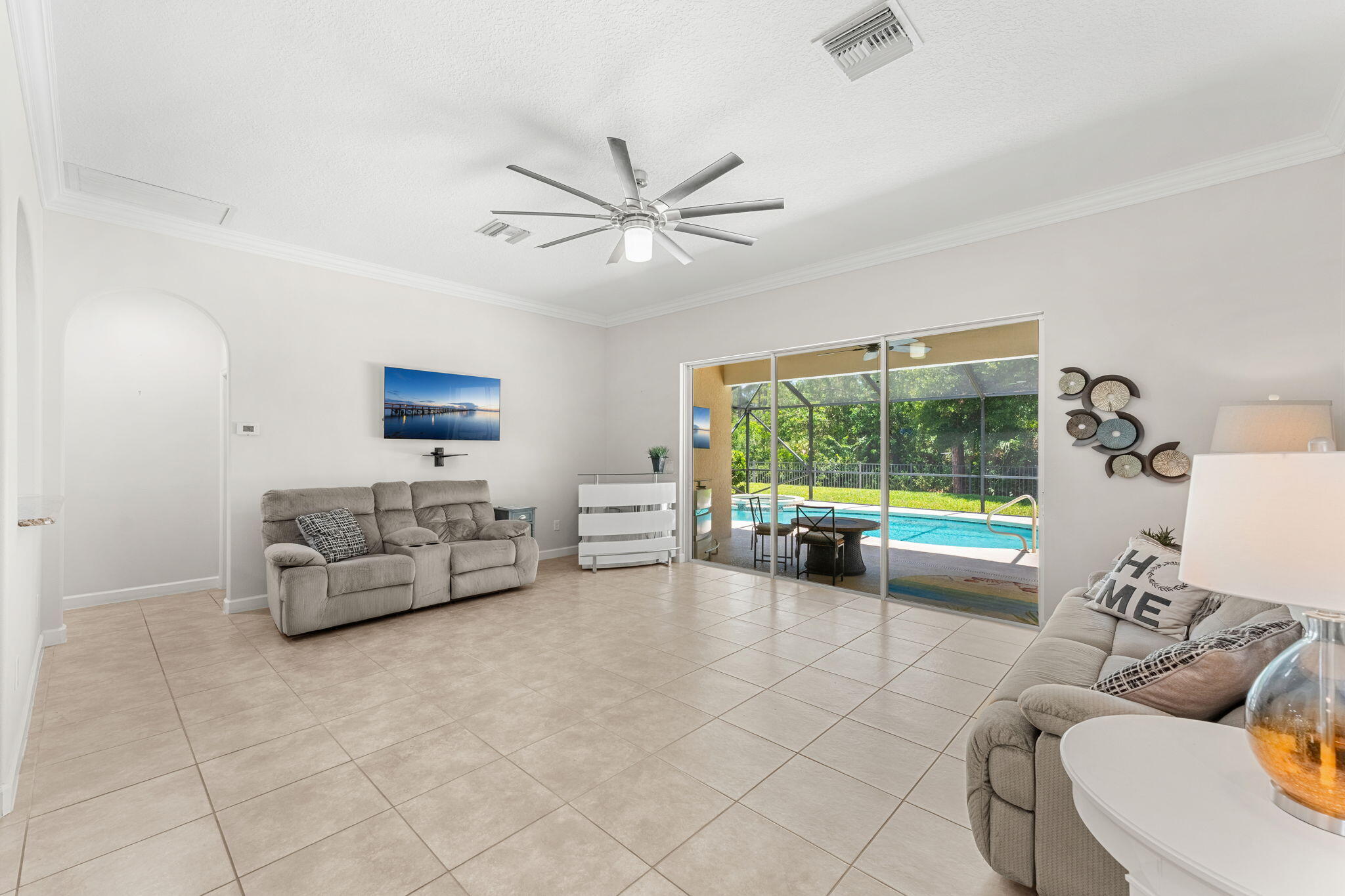 7657 Fieldstone Ranch Square Vero Beach, FL 32967 - Photo 15 of 52 a living room with furniture and a large window