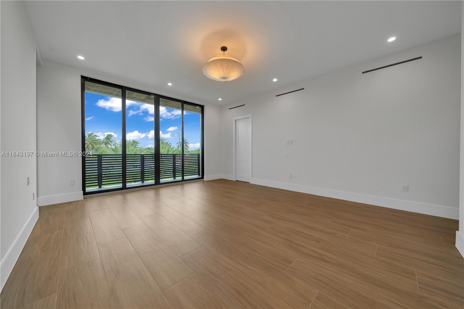 8821 Southwest 56th Street Miami, FL 33165 - Photo 16 of 49 a view of room with wooden floor and fan