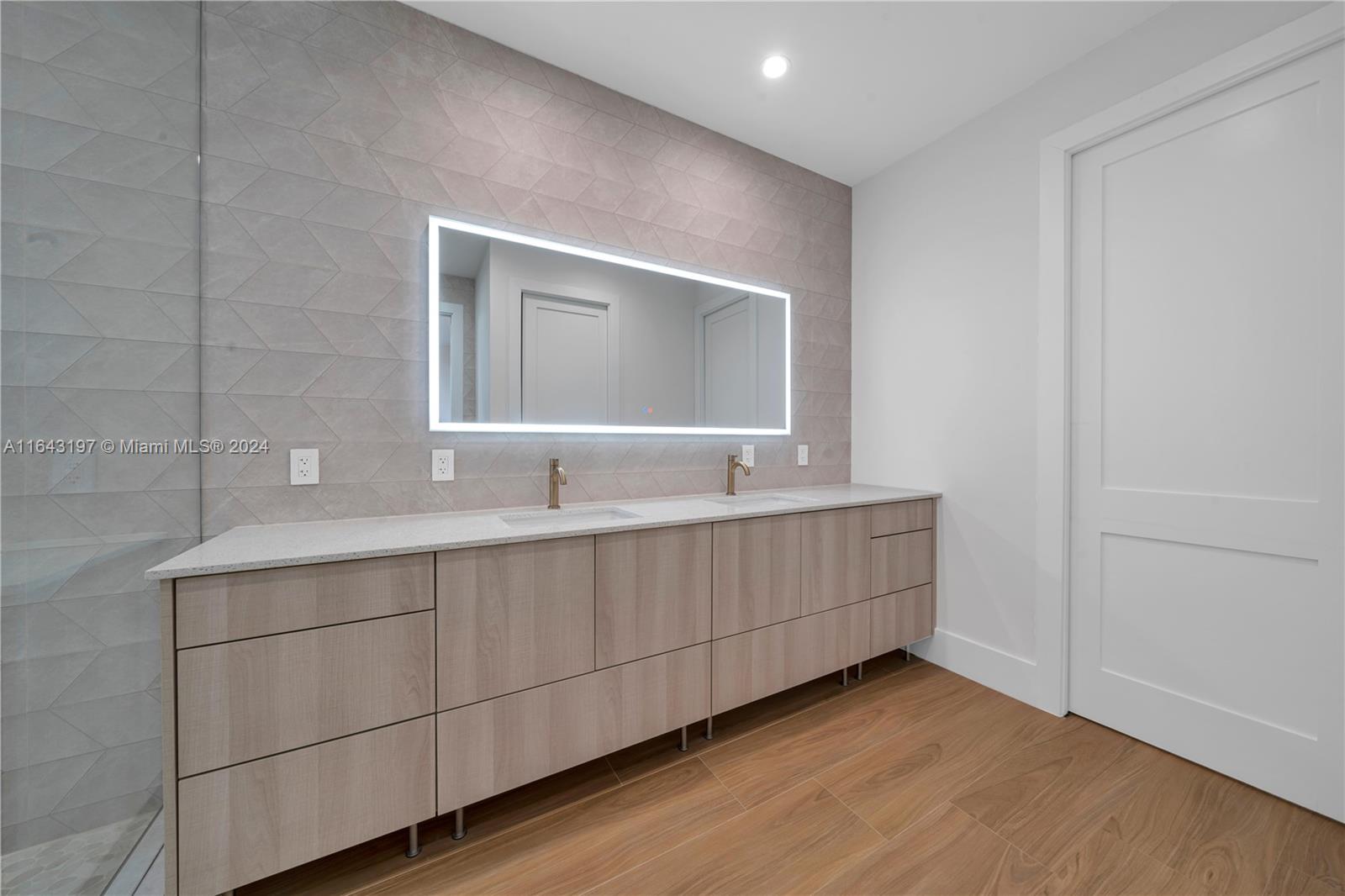 8821 Southwest 56th Street Miami, FL 33165 - Photo 17 of 49 a bathroom with a double vanity sink and mirror