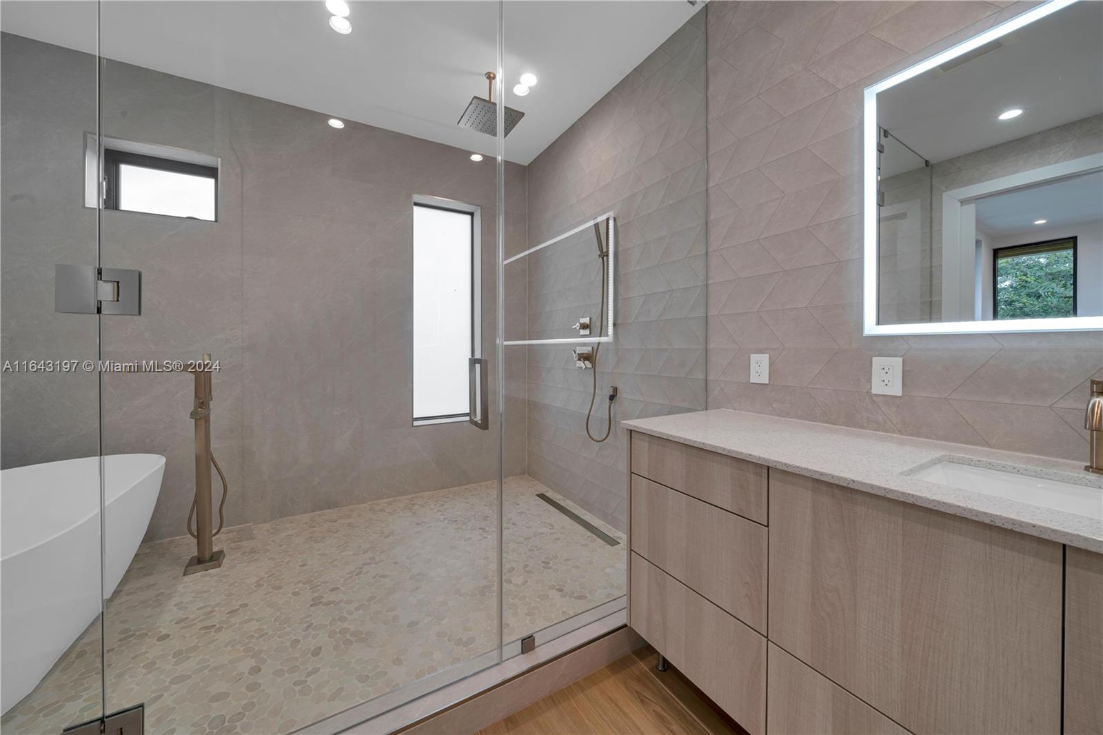 8821 Southwest 56th Street Miami, FL 33165 - Photo 18 of 49 a bathroom with a sink a toilet a mirror and shower