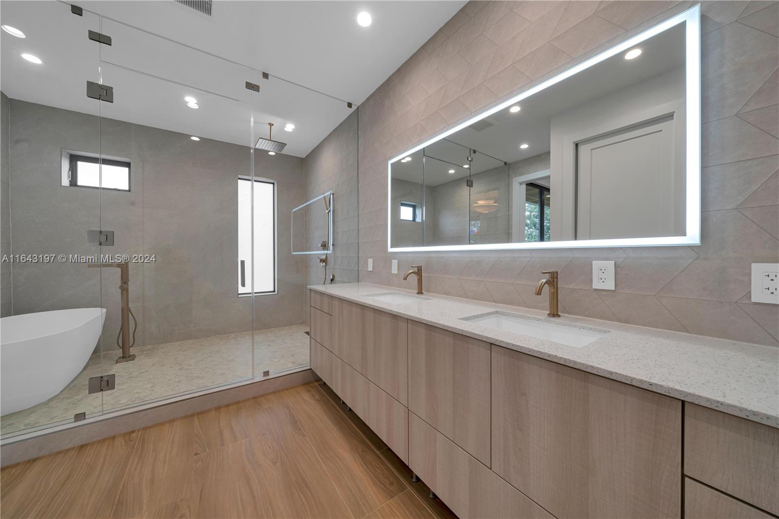 8821 Southwest 56th Street Miami, FL 33165 - Photo 19 of 49 a bathroom with a granite countertop sink mirror and bathtub