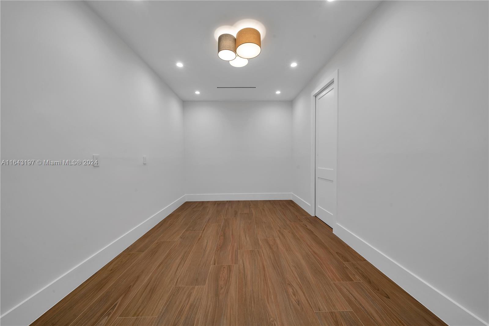 8821 Southwest 56th Street Miami, FL 33165 - Photo 20 of 49 a view of an empty room with wooden floor