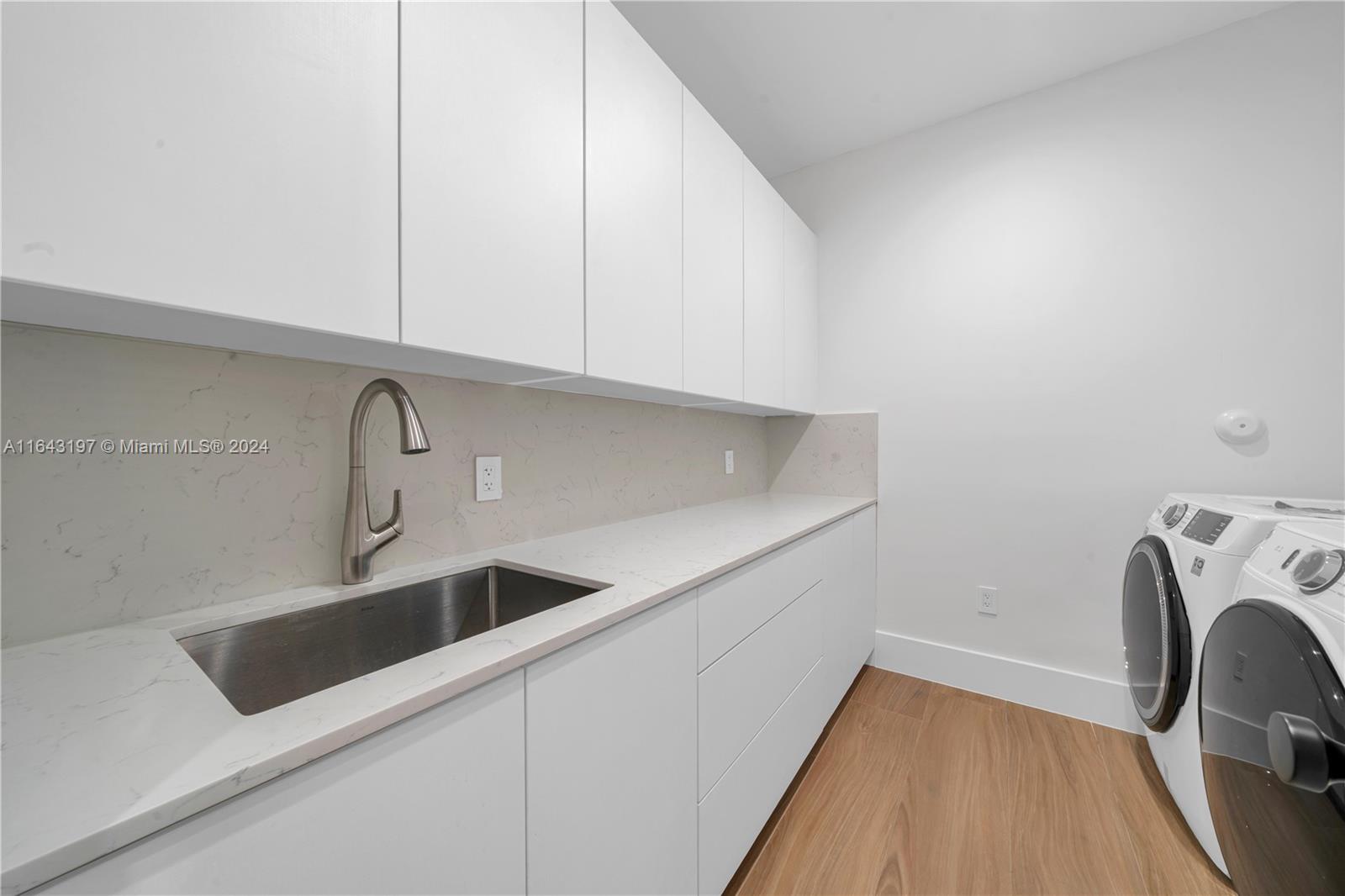 8821 Southwest 56th Street Miami, FL 33165 - Photo 21 of 49 a view of a kitchen sink with a washer and dryer