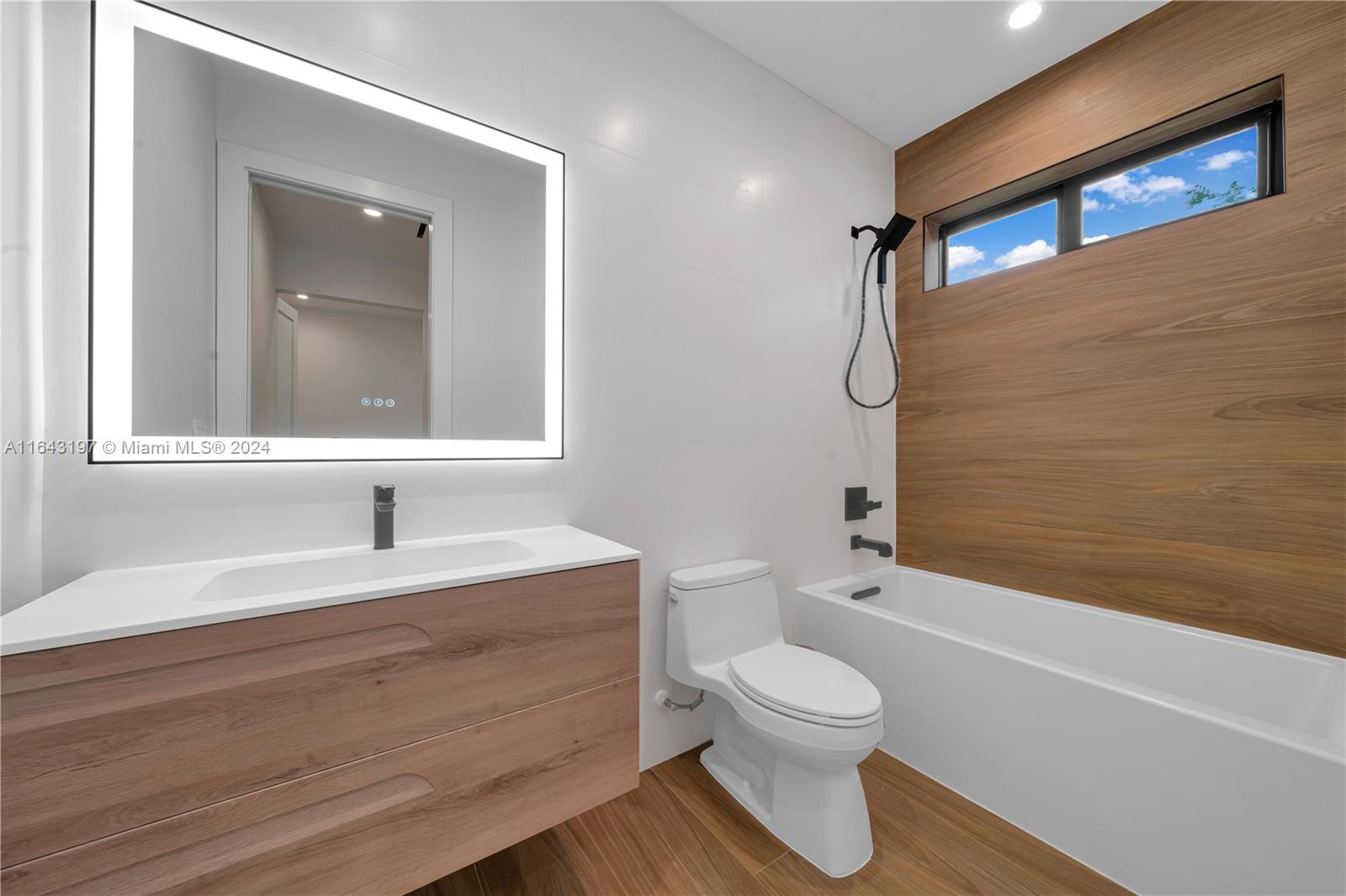 8821 Southwest 56th Street Miami, FL 33165 - Photo 24 of 49 a bathroom with a toilet a sink and a bathtub