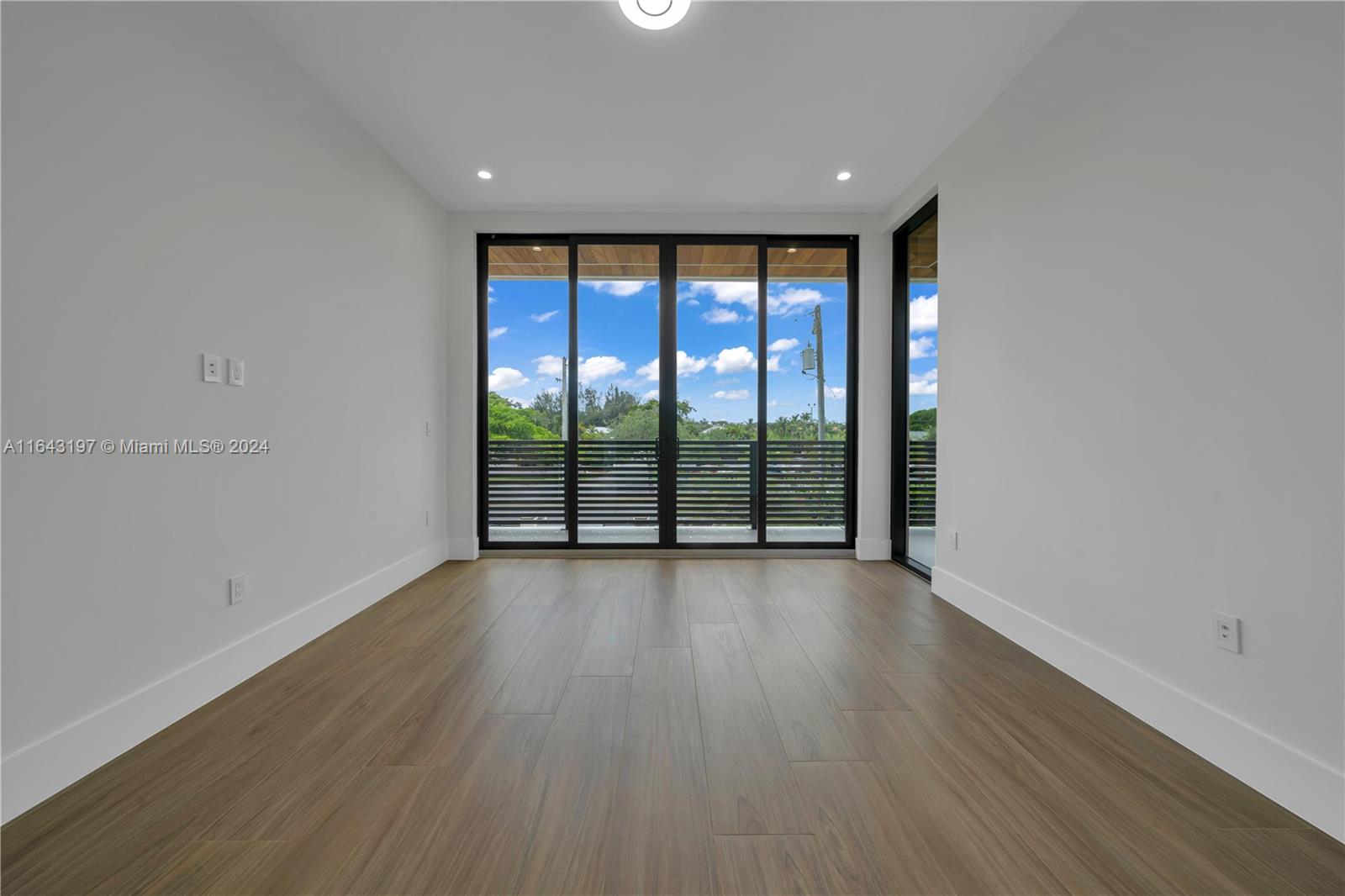 8821 Southwest 56th Street Miami, FL 33165 - Photo 26 of 49 wooden floor in an empty room with a window