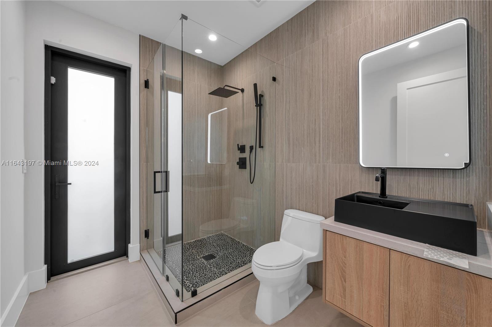 8821 Southwest 56th Street Miami, FL 33165 - Photo 32 of 49 a bathroom with a toilet a sink and a mirror