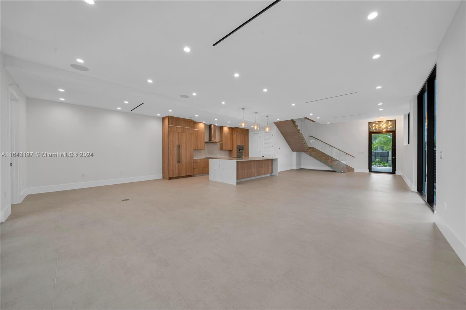 8821 Southwest 56th Street Miami, FL 33165 - Photo 4 of 49 an empty room with a wooden floor and windows