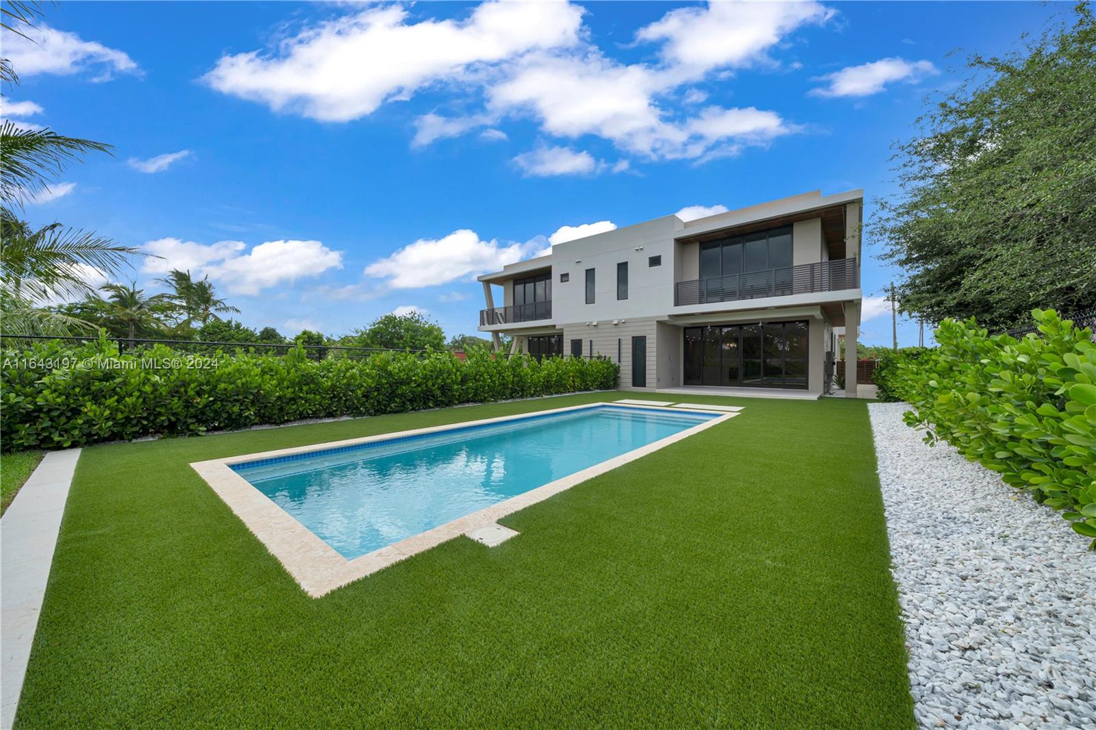 8821 Southwest 56th Street Miami, FL 33165 - Photo 43 of 49 a view of an house with swimming pool lawn chairs and a yard