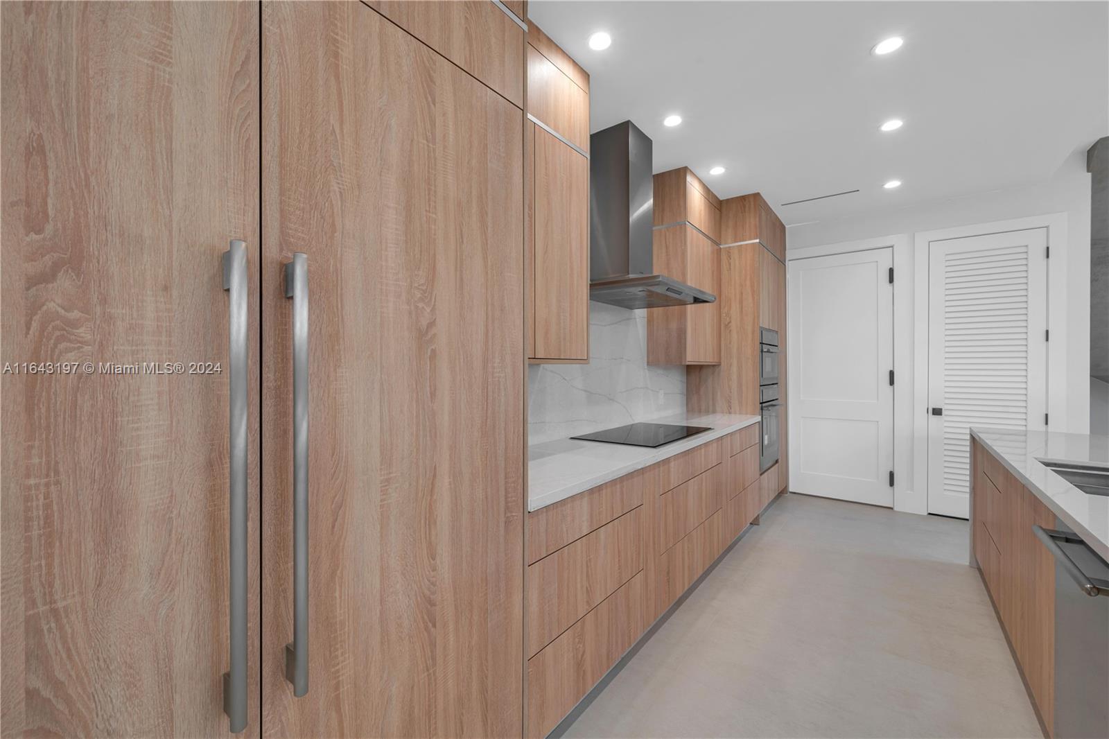 8821 Southwest 56th Street Miami, FL 33165 - Photo 10 of 49 a large white kitchen with a sink and refrigerator