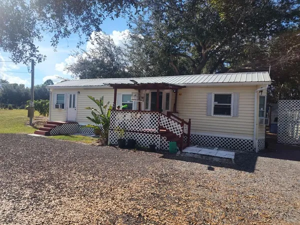 a view of a house with a yard and roof