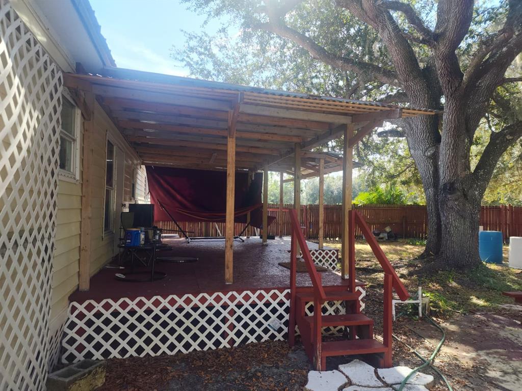 82 Silvio Road Lake Wales, FL 33898 - Photo 5 of 13 a view of a patio with a table chairs and a backyard