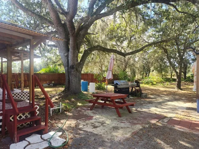 a view of a backyard with sitting area