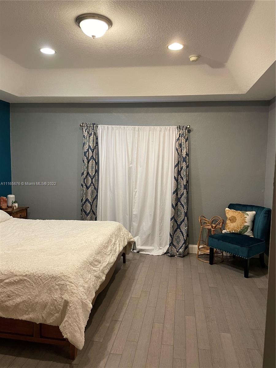 22025 Southwest 88th Path Cutler Bay, FL 33190 - Photo 17 of 34 a bedroom with a bed and a window