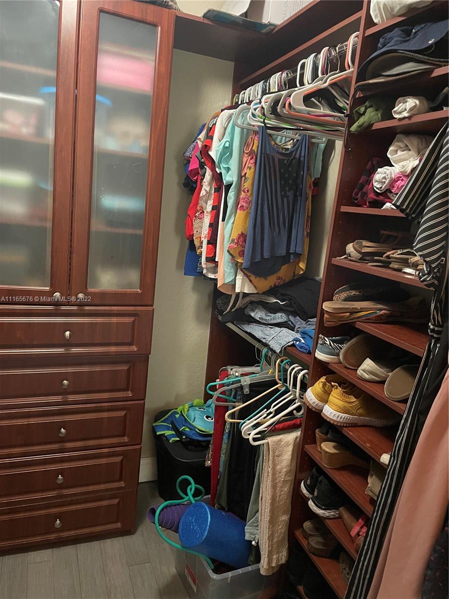 22025 Southwest 88th Path Cutler Bay, FL 33190 - Photo 19 of 34 a view of walk in closet with clothes
