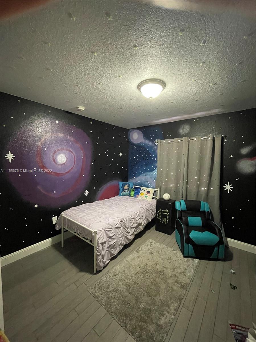 22025 Southwest 88th Path Cutler Bay, FL 33190 - Photo 23 of 34 a spacious bedroom with a bed and a large mirror