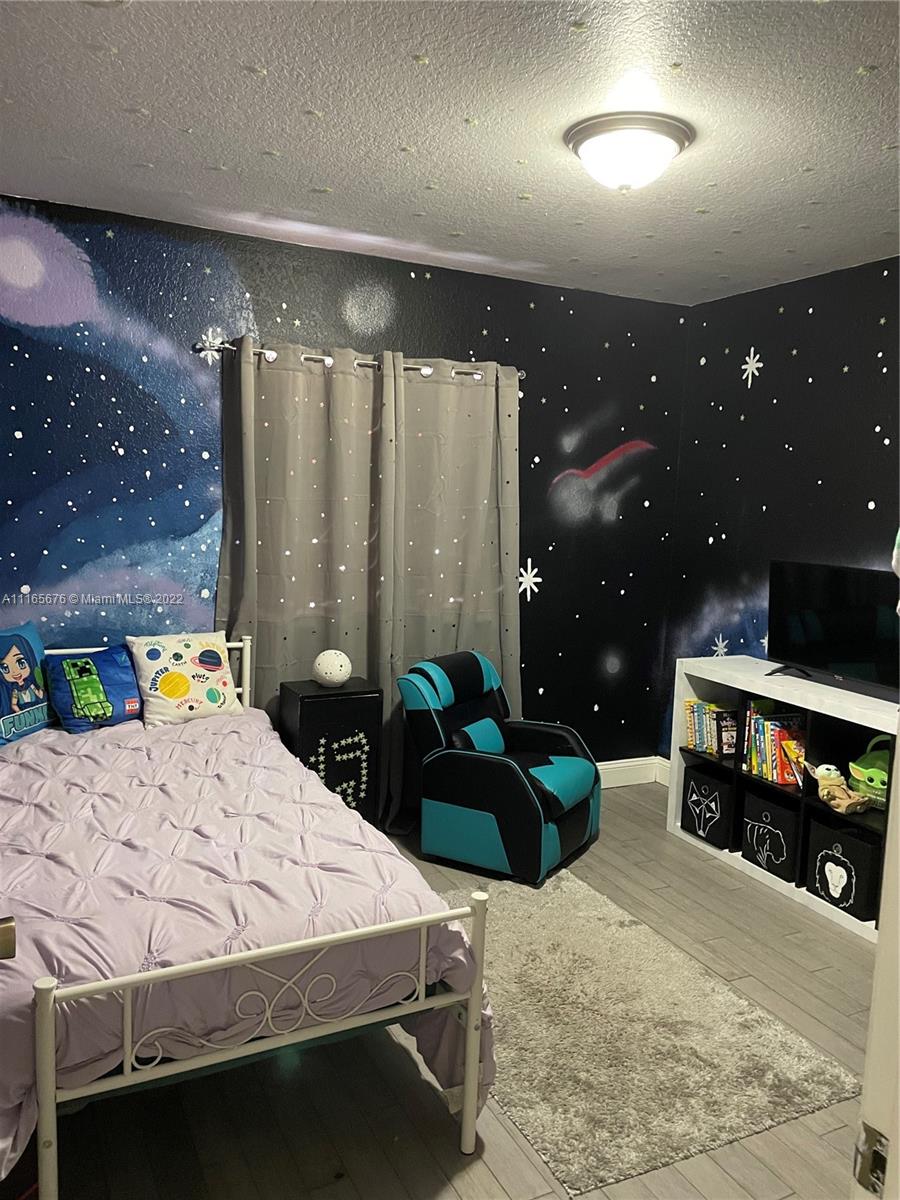 22025 Southwest 88th Path Cutler Bay, FL 33190 - Photo 24 of 34 a bed room with a bed window and a table