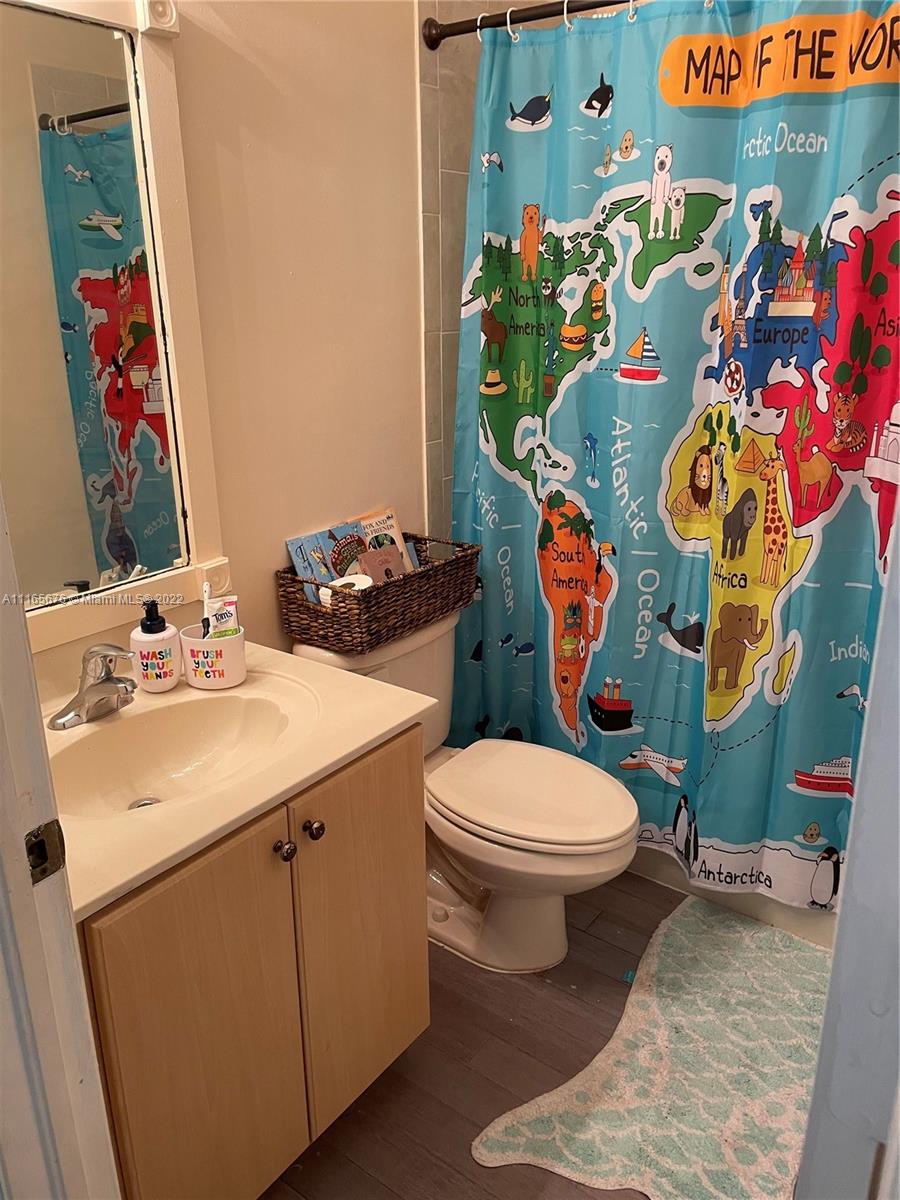 22025 Southwest 88th Path Cutler Bay, FL 33190 - Photo 27 of 34 a bathroom with a sink mirror vanity and toilet