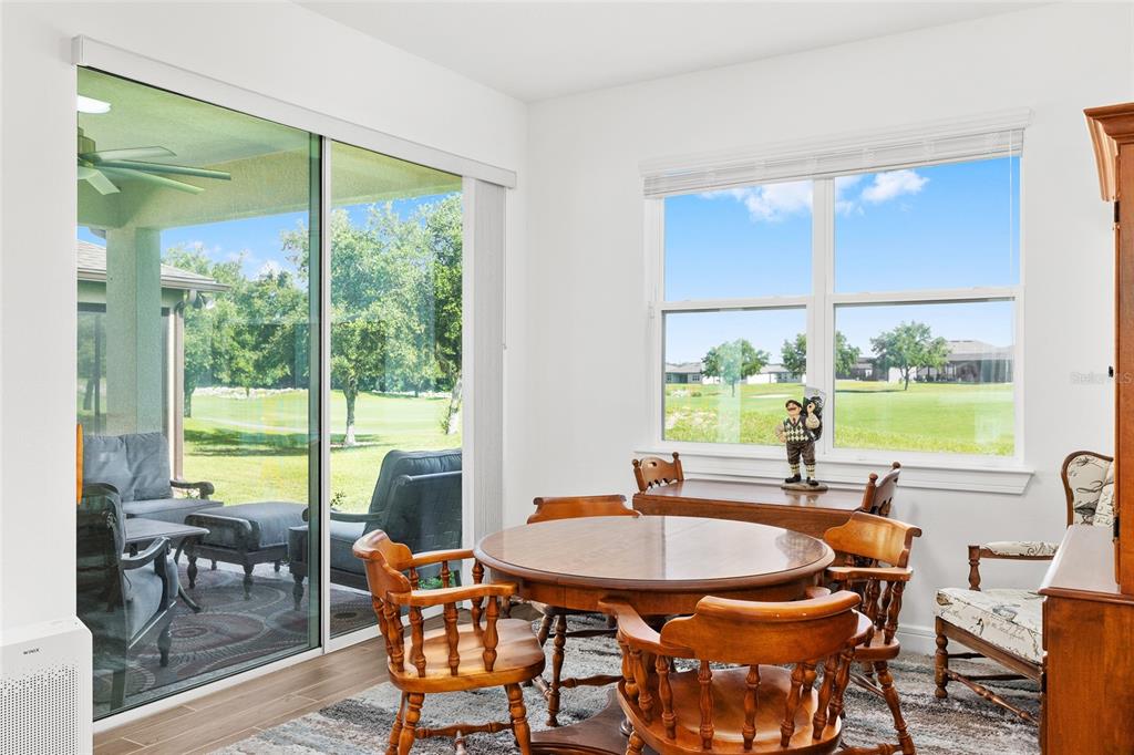 8989 Southwest 57th Pl Road Ocala, FL 34481 - Photo 18 of 47 a dining room with furniture a livingroom view and outdoor view