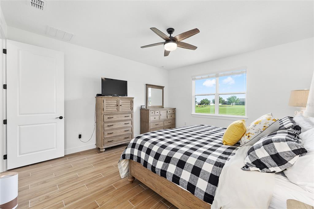8989 Southwest 57th Pl Road Ocala, FL 34481 - Photo 22 of 47 a bedroom with a bed and wooden floor