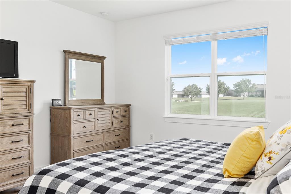 8989 Southwest 57th Pl Road Ocala, FL 34481 - Photo 24 of 47 a bedroom with a bed and a mirror