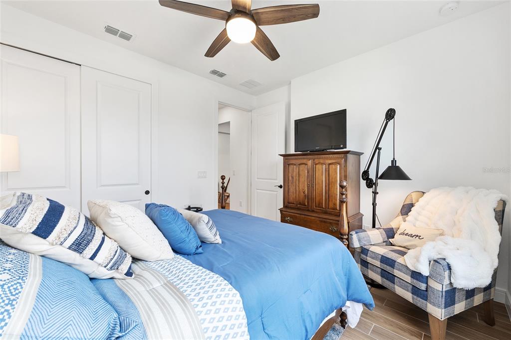 8989 Southwest 57th Pl Road Ocala, FL 34481 - Photo 29 of 47 a bedroom with a bed and wooden floor