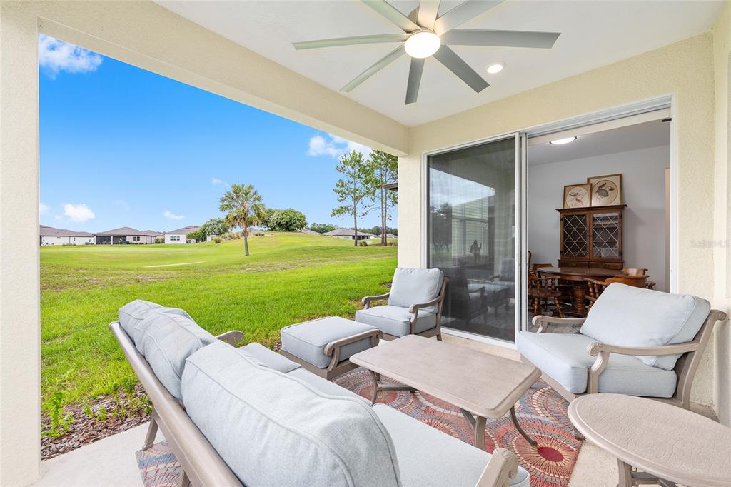 8989 Southwest 57th Pl Road Ocala, FL 34481 - Photo 35 of 47 a living room with patio furniture and a garden