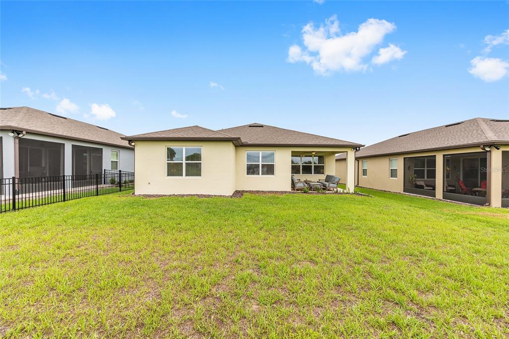 8989 Southwest 57th Pl Road Ocala, FL 34481 - Photo 42 of 47 a view of a house with a backyard